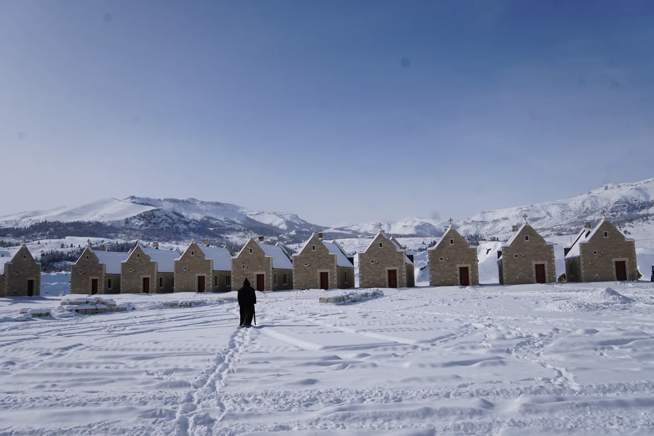 The monastery hermitages beneath snow-covered mountains
