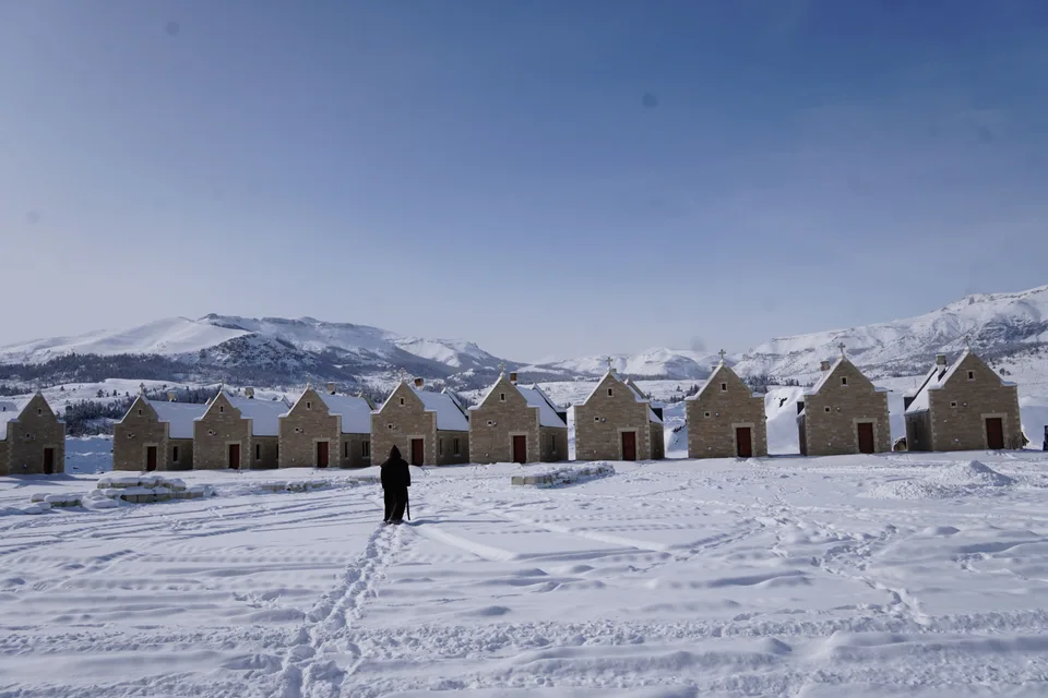 A monk walking across the monastery cloister in winter