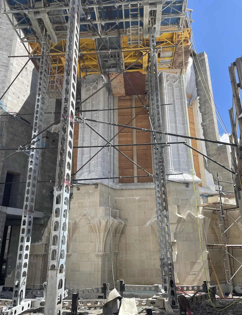 Scaffolding and steel bracing around newly set granite walls of the Chapel apse