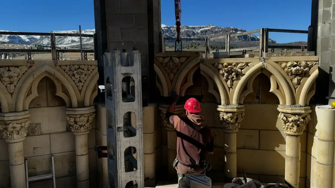 A monk setting carved stone in the Chapel arcade