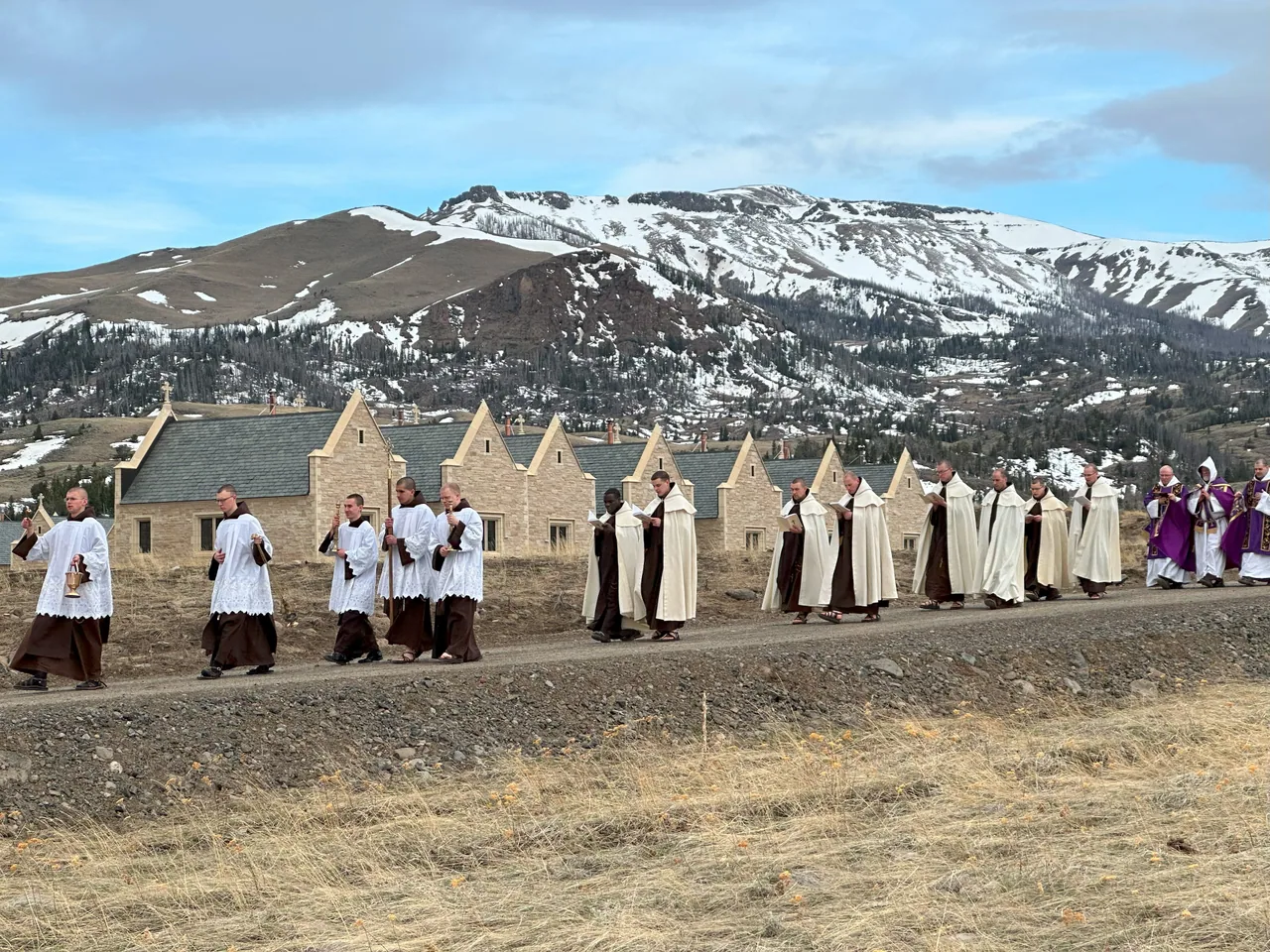 The monks walking in a Rogation procession beneath the mountains